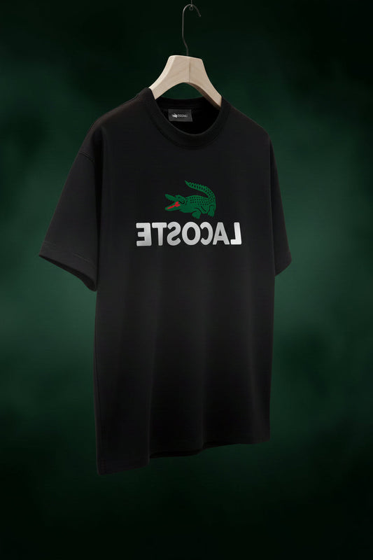 Black Lacoste t-shirt on a hanger in a stylish room.